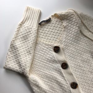 white-cream cardigan with brown button detailing